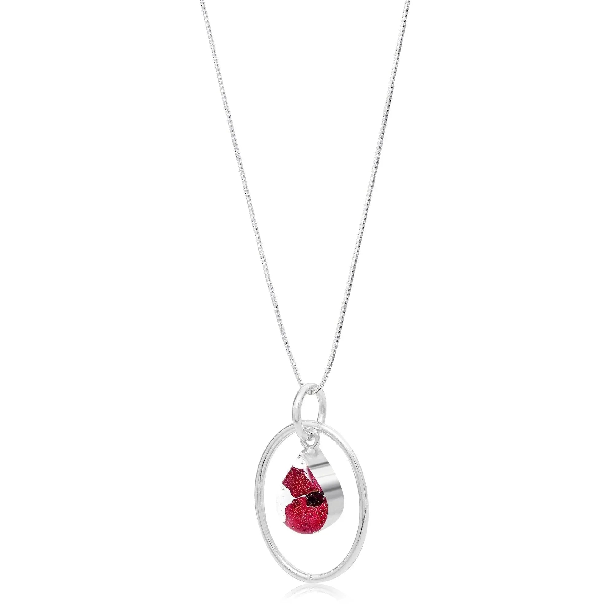 Poppy necklace by Shrieking Violet® Sterling silver teardrop pendant with a mini poppy (Euphorbia Milii) & silver oval hoop.